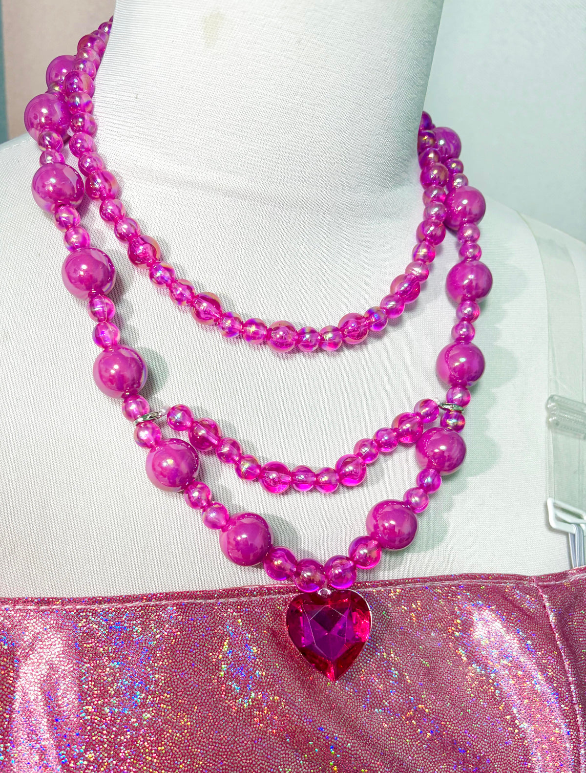 Pink heart necklace and shimmering bodice detail of the Princess Alexa cosplay dress