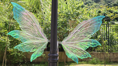 Iridescent blue purple and green color-shifting fairy cosplay wings with shoulder straps and decorative flowers
