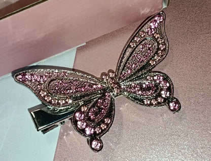 Close-up of a pink rhinestone butterfly hair clip for Barbie cosplay