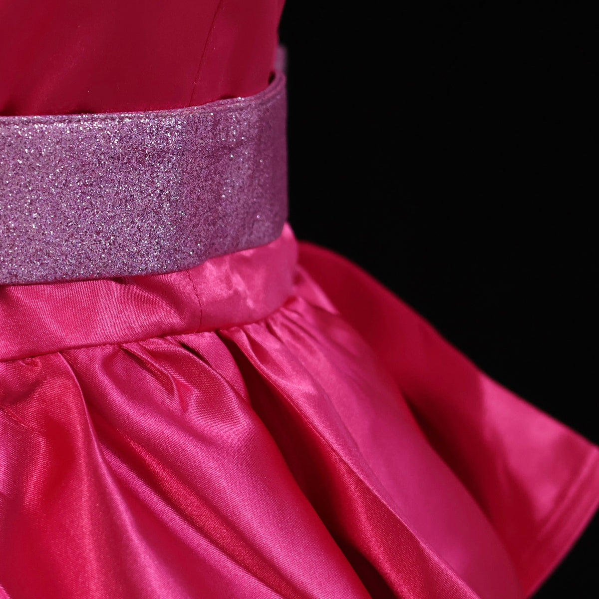 Close-up of the glitter belt and pink satin waist on the Barbie A Fairy Secret costume