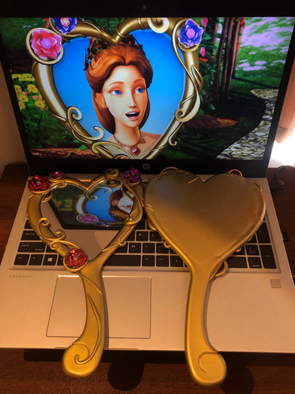 Barbie Diamond Castle handheld mirror displayed in front of an animated scene