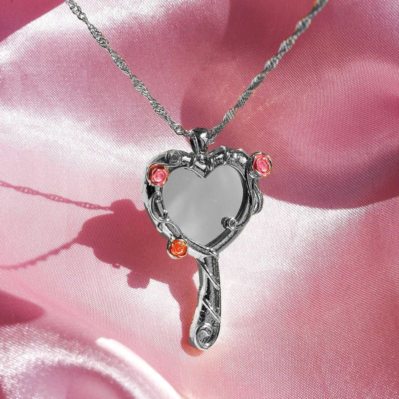 Close-up of the silver-tone Diamond Castle heart mirror pendant necklace