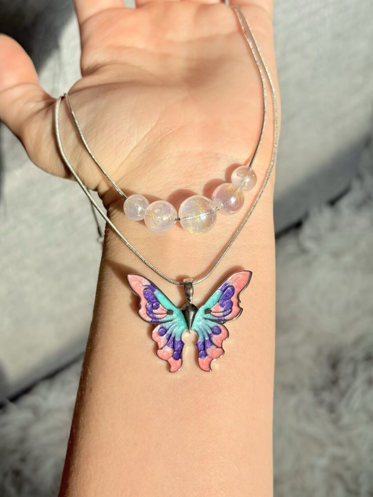Barbie Fairytopia butterfly pendant necklace worn with a colorful outfit