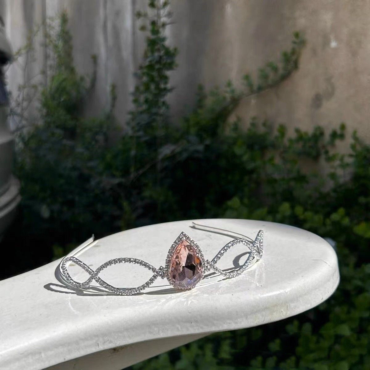 Silver-tone Barbie princess tiara displayed in an outdoor setting