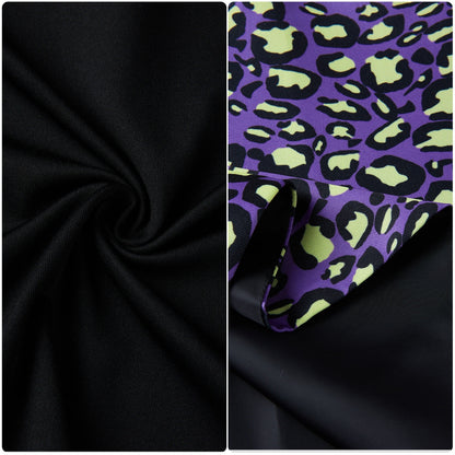 Close-up of black top fabric and purple leopard-print skirt fabric with lime-green accents