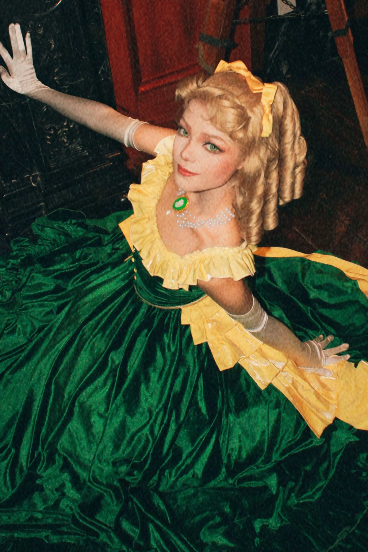 Close-up of the Eden Starling costume with a green bodice and yellow ruffle details