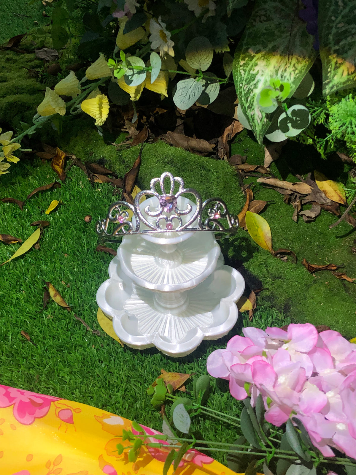 Silver princess crown displayed with flowers