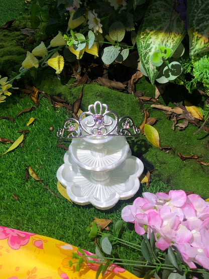 Silver princess crown displayed with flowers