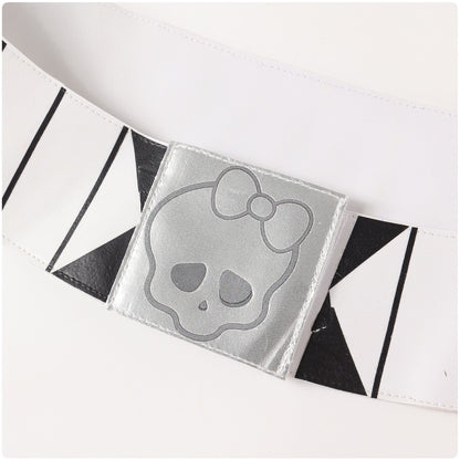 Close-up of the white belt with black graphic details and a silver-tone skull buckle