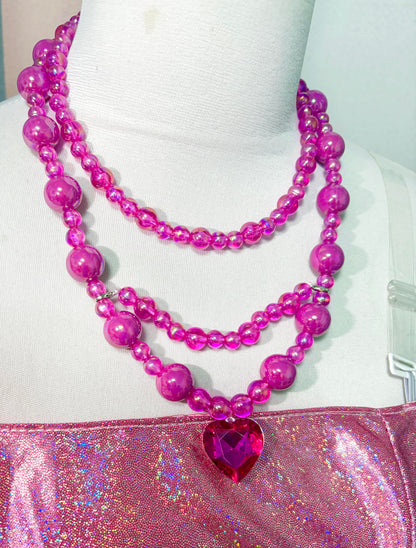 Pink heart necklace and shimmering bodice detail of the Princess Alexa cosplay dress
