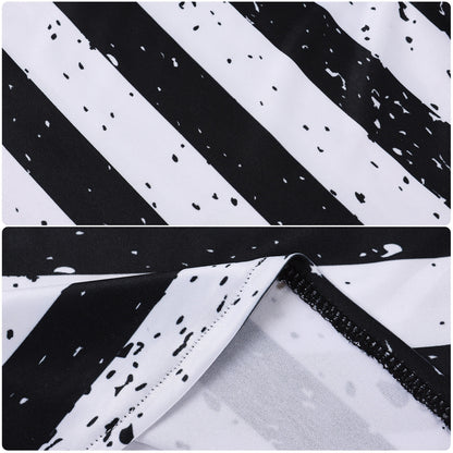 Close-up of black and white striped fabric with a speckled print
