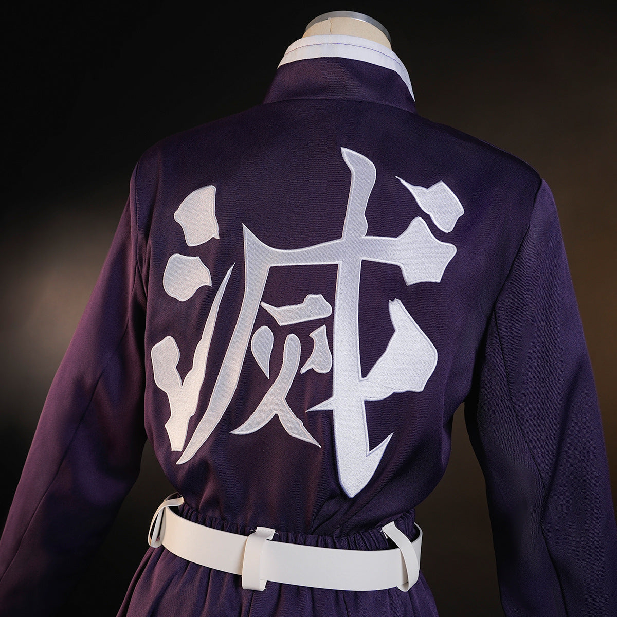 Close-up of the white Japanese character on the back of Shinobu Kocho’s dark purple uniform