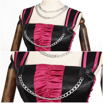 Close-up of the striped shoulder straps, pink front panel and silver-tone chains